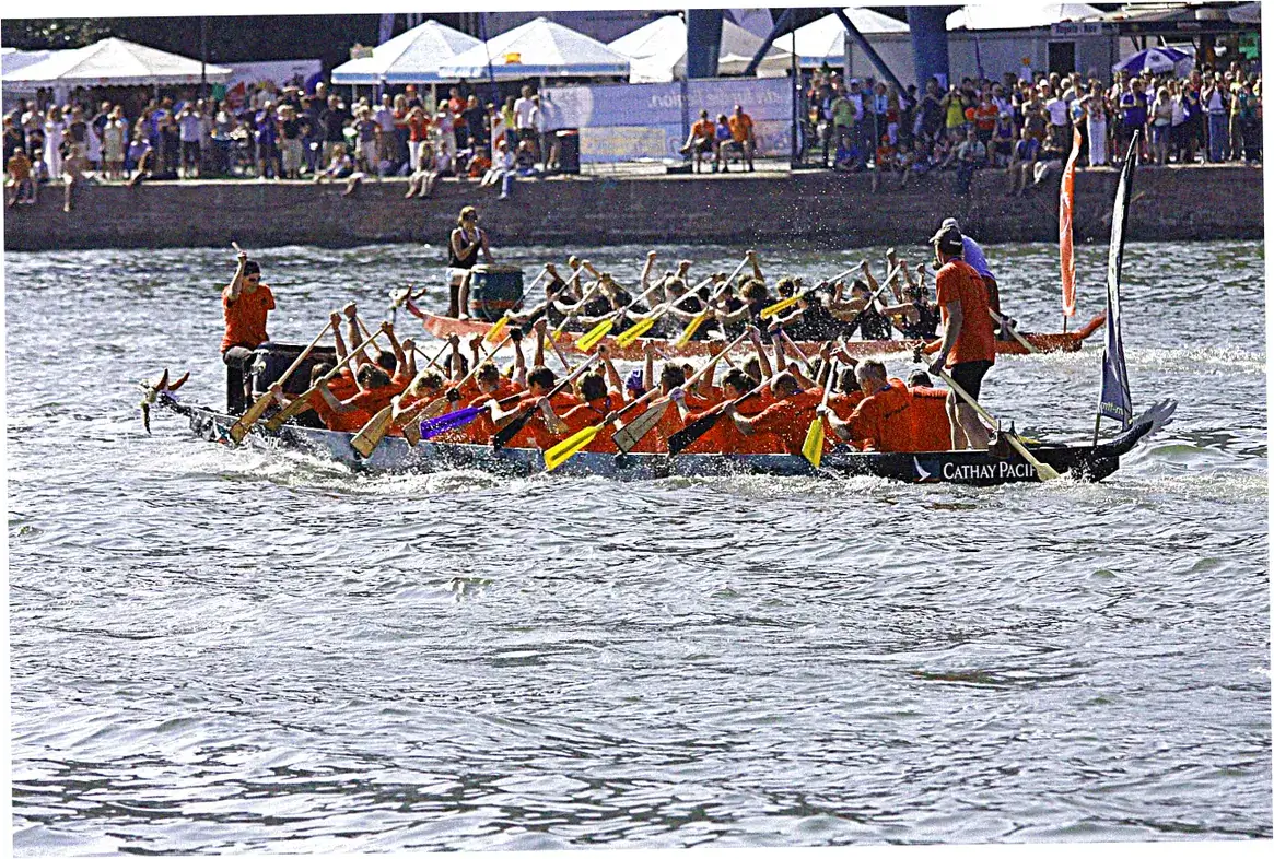 How do dragon boats compare to outrigger canoes?